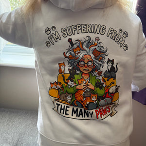 person wearing a white hoodie with a tattoo style design of a woman with lots of cats