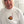 Person wearing a white shirt with a logo on the chest