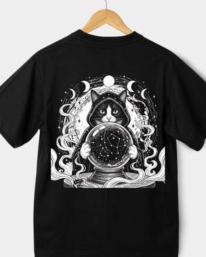 Black t-shirt with a cat holding a crystal ball design on a white background