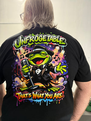 Person wearing a black t-shirt with a colorful cartoon frog graphic design and text.