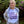 Person wearing a white t-shirt with text and graphics, standing outdoors with greenery in the background