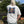 A person outdoors wearing a white short-sleeve T-shirt with a large graphic print of a teddy bear on the back, paired with light gray pants.