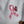 A close-up of a white fabric surface featuring a pink awareness ribbon and butterfly graphic printed on it.