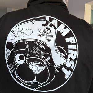 Black hoodie with white graphic jam first and bear design and text on a plain background