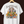 White t-shirt with a cartoon design of a person surrounded by cats and text on a dark background