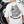 Person wearing a white t-shirt with a cartoon cat and text design talk to the toe beans on the back.