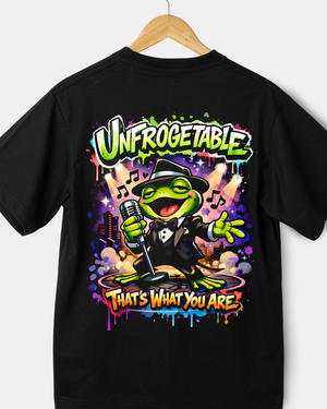 Black t-shirt with a colorful graphic of a frog singing into a microphone, text 'Unfrogetable That's What You Are', on a white background.